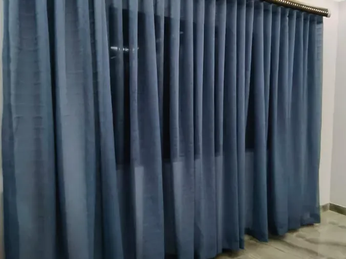 Navy sheer wave curtains on a rod in a Cape Town room