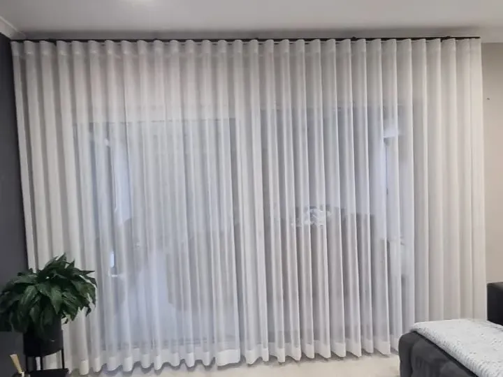 White sheer wave curtains in a Cape Town bedroom