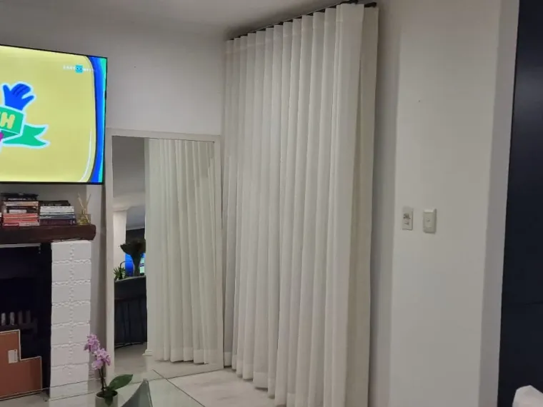 Cream wave curtains beside a fireplace in a Cape Town lounge