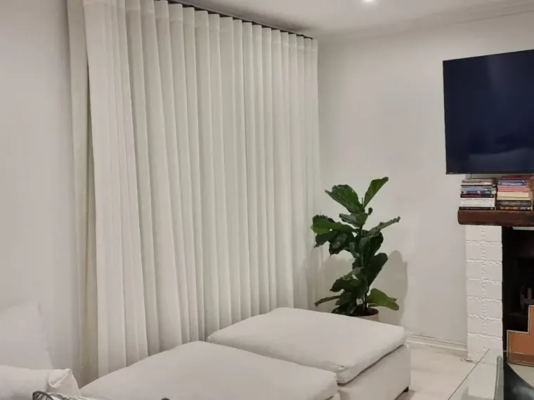 Cream wave curtains beside a fireplace in a Cape Town lounge